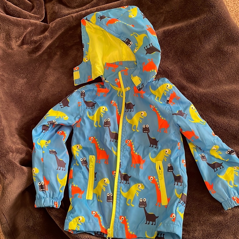 Boys rain jacket, blue with dinosaurs, size 4-6.